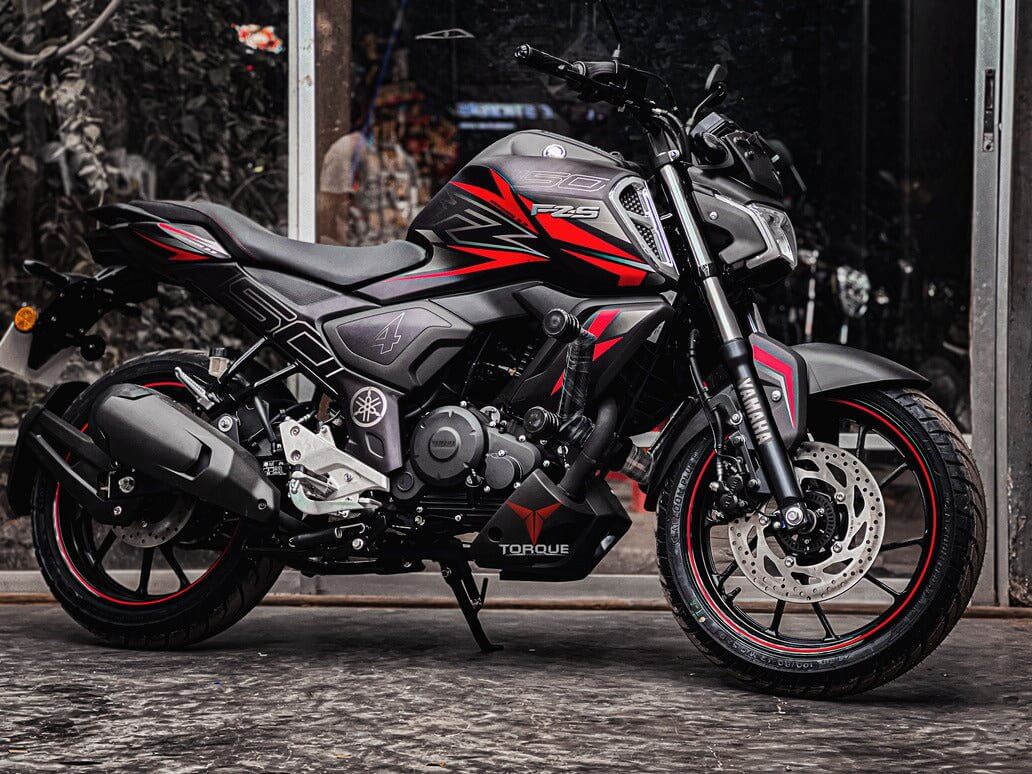 YAMAHA FZS V3/V4 motorcycle in black with red accents, displayed on a product page. Side view showcasing sleek design and features.