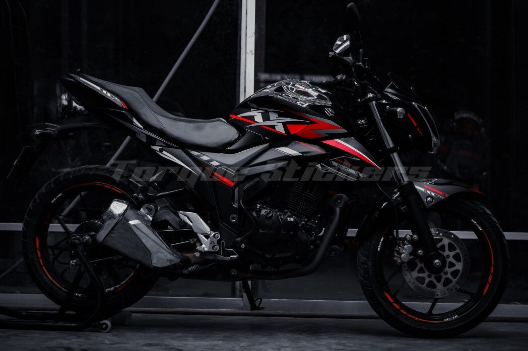 Side view of a motorcycle featuring the GIXXER MONOTONE XX DECAL SET, showcasing sleek black and red decals.